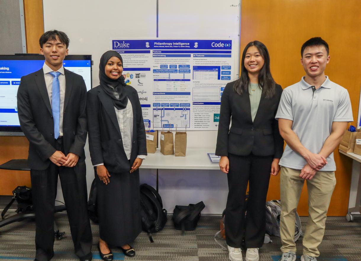 A group of four Code+ students stand in front of their project poster.